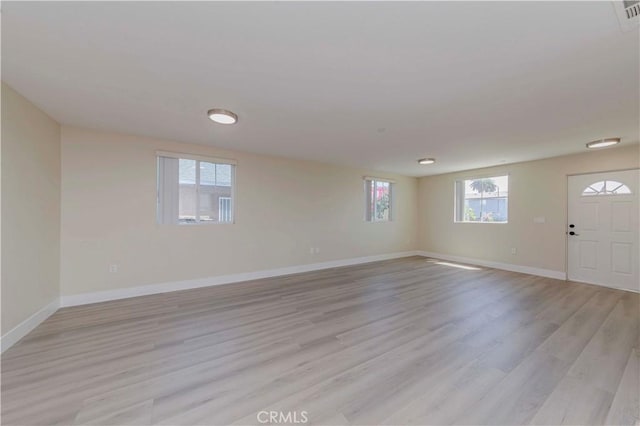 8711 Mckinley Pl, Los Angeles, CA 90002 - foyer entrance with baseboards and light wood-style floors