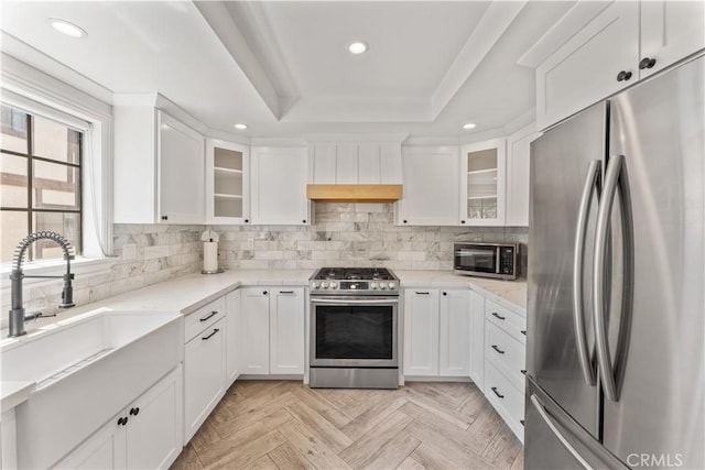 1814 Grant Ave Unit 7, Redondo Beach, CA 90278 - kitchen with appliances with stainless steel finishes, recessed lighting, a tray ceiling, white cabinets, and decorative backsplash