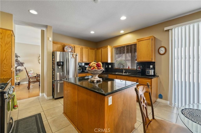 39243 Nicole Dr, Palmdale, CA 93551 - kitchen with stainless steel appliances, a kitchen island, light tile patterned floors, a sink, and recessed lighting