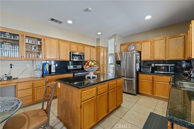39243 Nicole Dr, Palmdale, CA 93551 - kitchen with appliances with stainless steel finishes, light tile patterned flooring, decorative backsplash, a center island, and recessed lighting