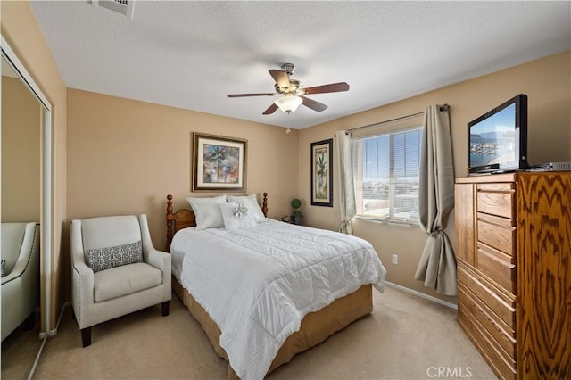 39243 Nicole Dr, Palmdale, CA 93551 - bedroom featuring light colored carpet, a closet, ceiling fan, baseboards, and a textured ceiling