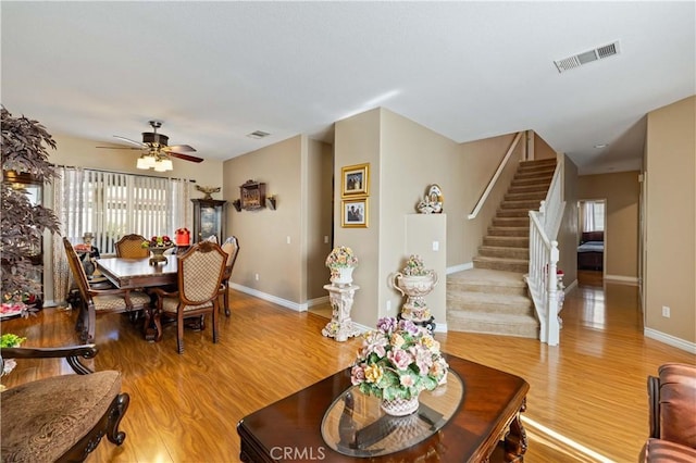39243 Nicole Dr, Palmdale, CA 93551 - living room featuring stairway, light wood-style floors, baseboards, and a ceiling fan