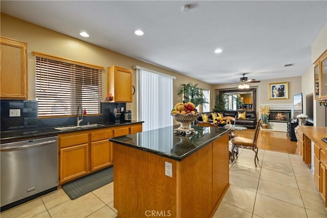 39243 Nicole Dr, Palmdale, CA 93551 - kitchen with stainless steel dishwasher, a sink, light tile patterned floors, backsplash, and ceiling fan