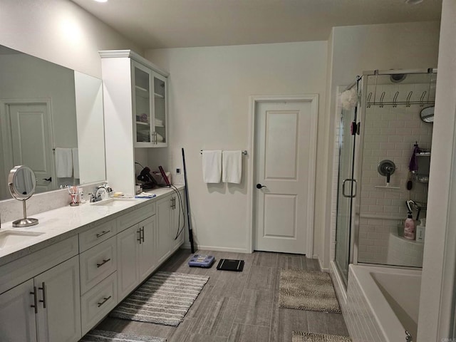 34885 Heartland Ln, Murrieta, CA 92563 - full bath featuring a stall shower, double vanity, a garden tub, and wood finished floors