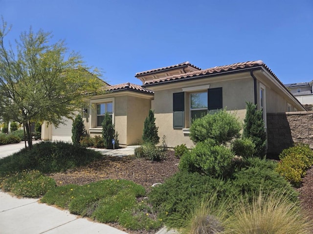 34885 Heartland Ln, Murrieta, CA 92563 - view of property exterior featuring stucco siding, a garage, and a tile roof