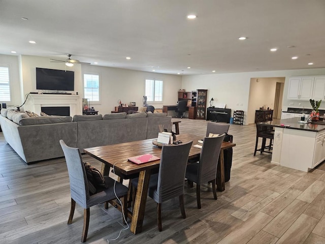 34885 Heartland Ln, Murrieta, CA 92563 - dining area with ceiling fan, light wood-style flooring, recessed lighting, and a fireplace
