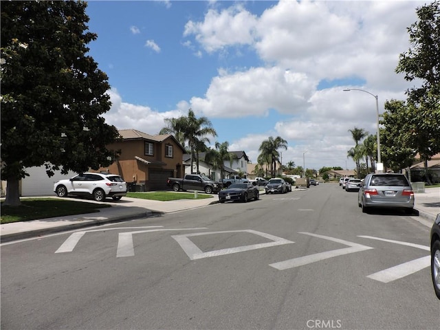 1326 Janes Way, Colton, CA 92324 - view of asphalt road with sidewalks, a residential view, curbs, and street lighting