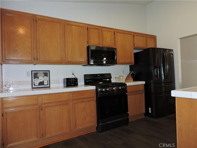 1326 Janes Way, Colton, CA 92324 - kitchen featuring black appliances, dark wood-style flooring, and brown cabinets