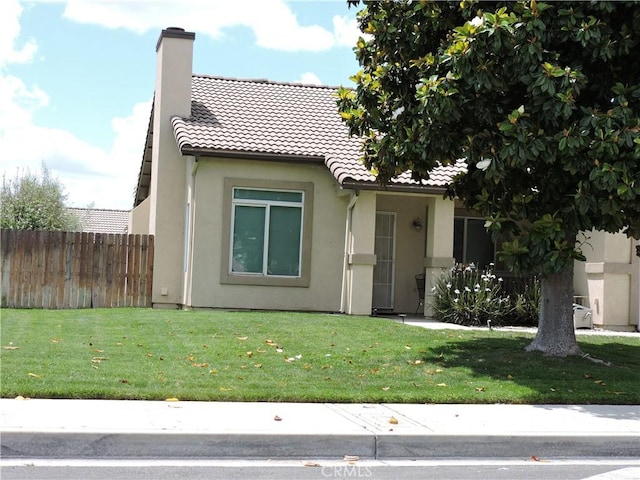 1326 Janes Way, Colton, CA 92324 - view of front of home featuring a tile roof, a chimney, and stucco siding
