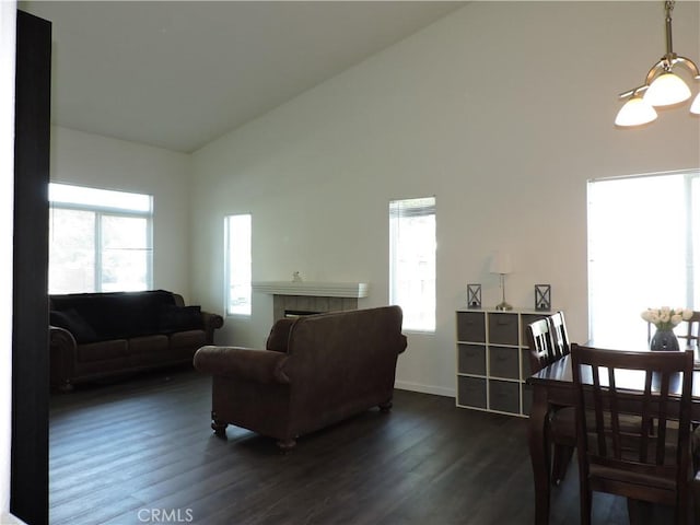 1326 Janes Way, Colton, CA 92324 - living area featuring dark wood finished floors, plenty of natural light, a tile fireplace, high vaulted ceiling, and baseboards