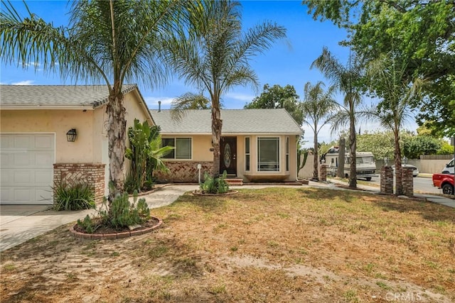 20554 Valerio St, Winnetka, CA 91306 - view of front of home with an attached garage, stucco siding, brick siding, and a front lawn