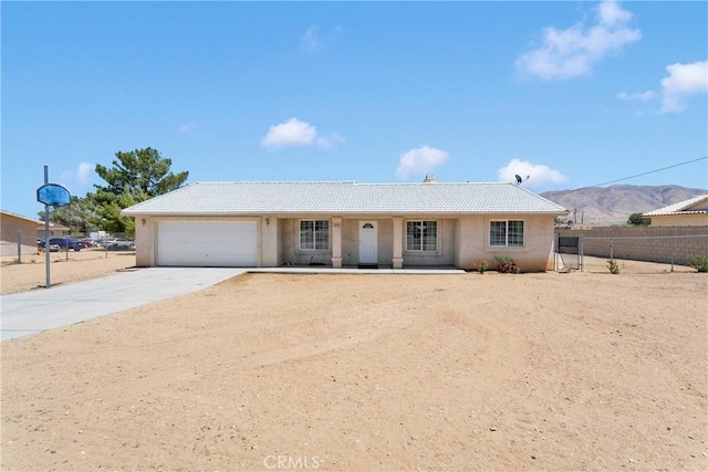 9275 Verdugo Ave, Hesperia, CA 92345 - single story home with an attached garage, driveway, stucco siding, a tile roof, and a mountain view