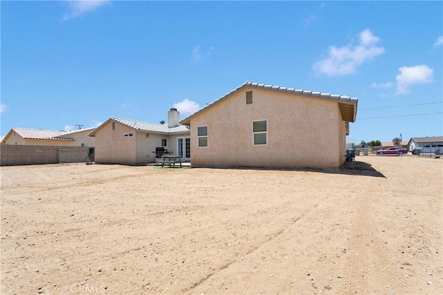 9275 Verdugo Ave, Hesperia, CA 92345 - rear view of property with a chimney and stucco siding