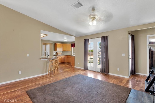 9275 Verdugo Ave, Hesperia, CA 92345 - living area featuring a ceiling fan, vaulted ceiling, light wood-type flooring, and baseboards