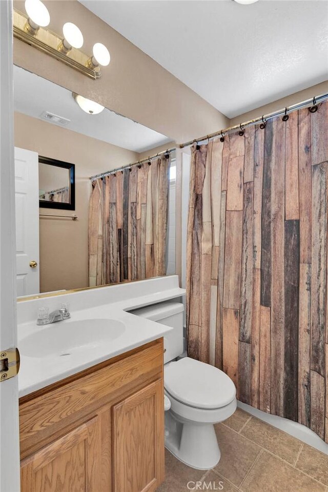 9275 Verdugo Ave, Hesperia, CA 92345 - full bathroom featuring vanity, toilet, tile patterned floors, and a shower with shower curtain
