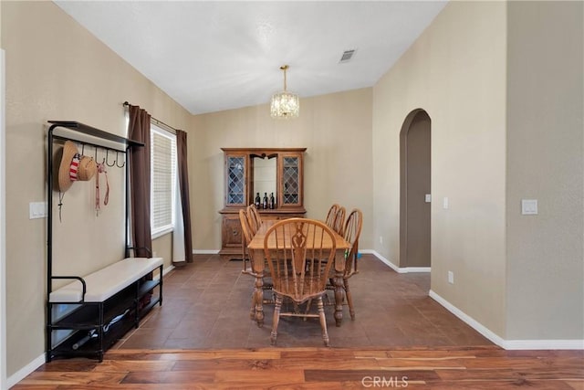 9275 Verdugo Ave, Hesperia, CA 92345 - dining area with arched walkways, a chandelier, baseboards, wood finished floors, and lofted ceiling