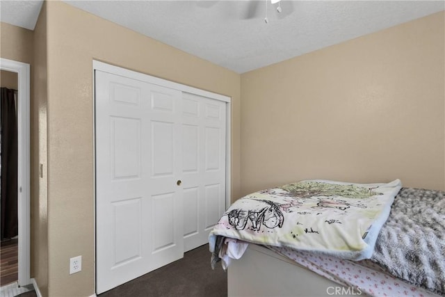 9275 Verdugo Ave, Hesperia, CA 92345 - bedroom featuring dark carpet, a closet, and ceiling fan