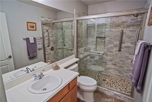 17334 Sierra Sunrise Ln, Canyon Country, CA 91387 - bathroom featuring vanity, toilet, a shower stall, and tile patterned flooring