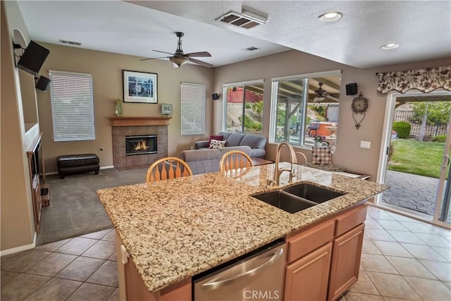 17334 Sierra Sunrise Ln, Canyon Country, CA 91387 - kitchen featuring a sink, dishwasher, ceiling fan, open floor plan, and an island with sink