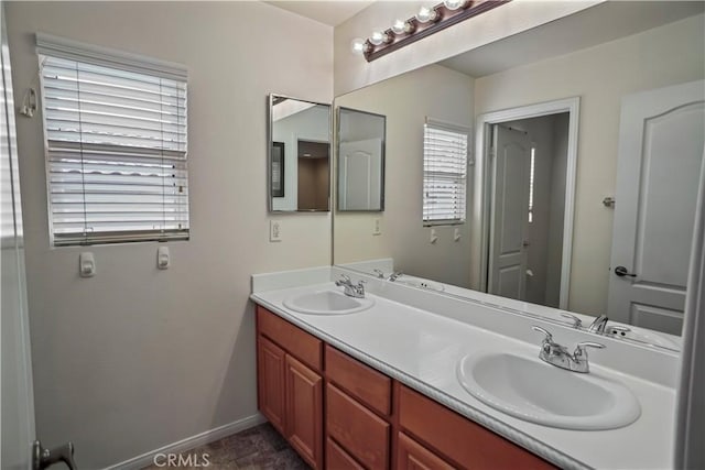 17334 Sierra Sunrise Ln, Canyon Country, CA 91387 - bathroom with double vanity, healthy amount of natural light, and baseboards