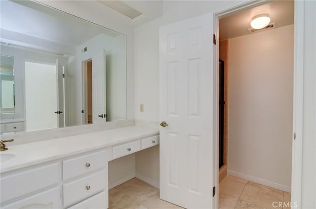 6052 Shadowbrook Cir, Huntington Beach, CA 92648 - full bath with vanity, baseboards, an enclosed shower, and tile patterned floors