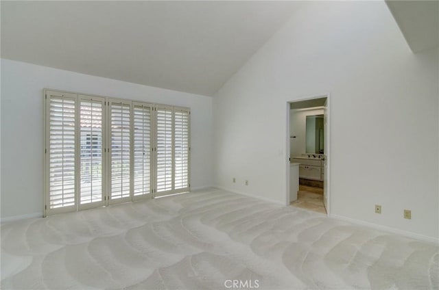 6052 Shadowbrook Cir, Huntington Beach, CA 92648 - unfurnished bedroom featuring carpet, vaulted ceiling, baseboards, access to exterior, and connected bathroom