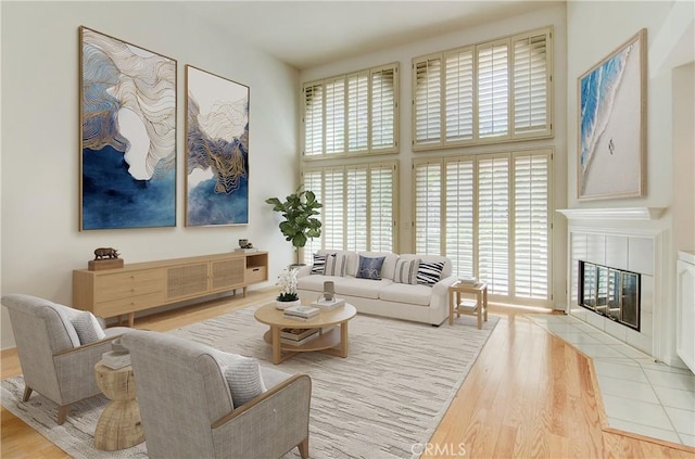 6052 Shadowbrook Cir, Huntington Beach, CA 92648 - living area with wood finished floors, a fireplace, and a high ceiling