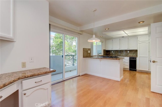 6052 Shadowbrook Cir, Huntington Beach, CA 92648 - kitchen featuring light wood-style flooring, white cabinets, tasteful backsplash, pendant lighting, and a peninsula