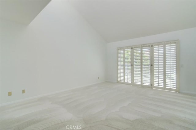 6052 Shadowbrook Cir, Huntington Beach, CA 92648 - carpeted empty room featuring lofted ceiling and baseboards