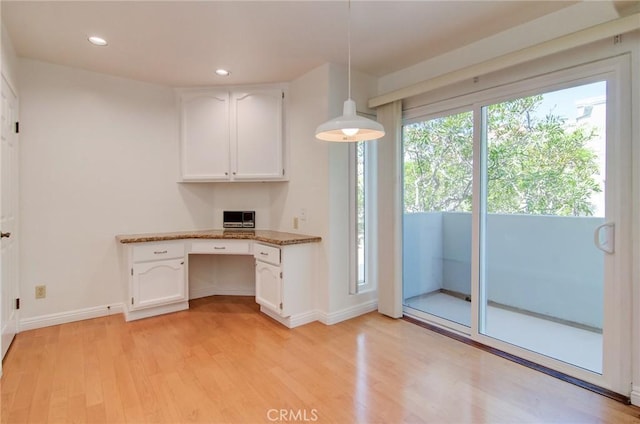 6052 Shadowbrook Cir, Huntington Beach, CA 92648 - kitchen featuring white cabinetry, light wood-style floors, baseboards, recessed lighting, and hanging light fixtures