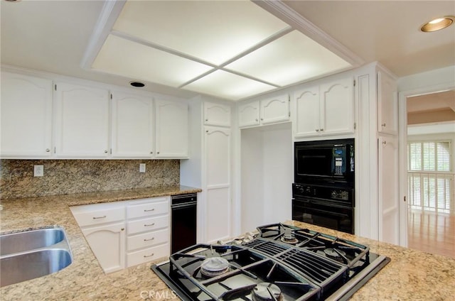 6052 Shadowbrook Cir, Huntington Beach, CA 92648 - kitchen with black appliances, backsplash, white cabinetry, a sink, and light stone countertops