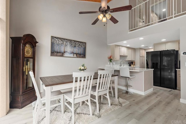 3404 Oak Cliff Dr Unit 2, Fallbrook, CA 92028 - dining room with a ceiling fan, light wood finished floors, a high ceiling, and baseboards