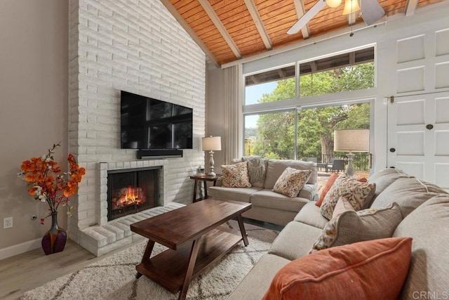 3404 Oak Cliff Dr Unit 2, Fallbrook, CA 92028 - living area with wood ceiling with exposed beams, a brick fireplace, a ceiling fan, wood finished floors, and baseboards