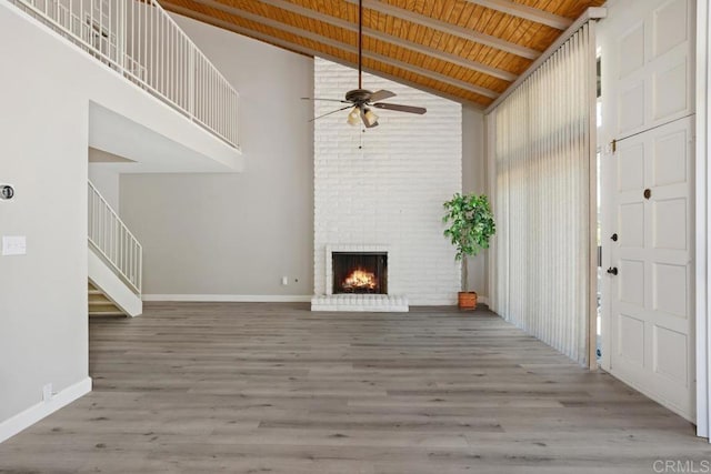 3404 Oak Cliff Dr Unit 2, Fallbrook, CA 92028 - unfurnished living room with a ceiling fan, high vaulted ceiling, a brick fireplace, wood ceiling with exposed beams, and wood finished floors