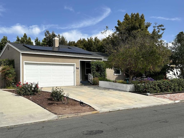 4349 Yale Ave, La Mesa, CA 91942 - single story home with driveway, roof mounted solar panels, an attached garage, and a chimney