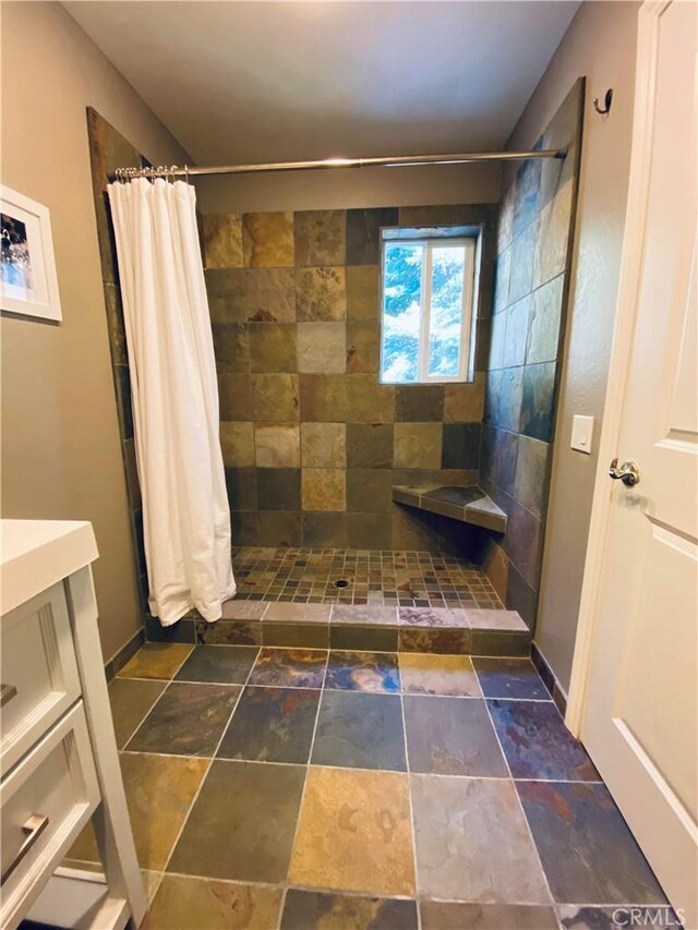 53434 Redwood Dr Unit B, Springville, CA 93265 - bathroom featuring tiled shower, vanity, and stone finish floors