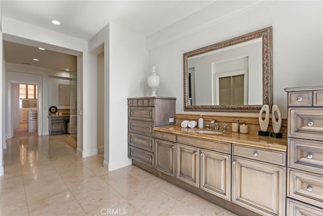 12 Via Avoria, Newport Coast, CA 92657 - bathroom with marble look tiles, vanity, baseboards, and recessed lighting