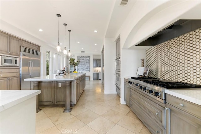 12 Via Avoria, Newport Coast, CA 92657 - kitchen featuring built in appliances, backsplash, light tile patterned floors, recessed lighting, and decorative light fixtures