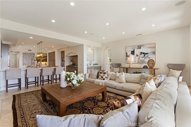 12 Via Avoria, Newport Coast, CA 92657 - living area with arched walkways, recessed lighting, a chandelier, and light tile patterned floors