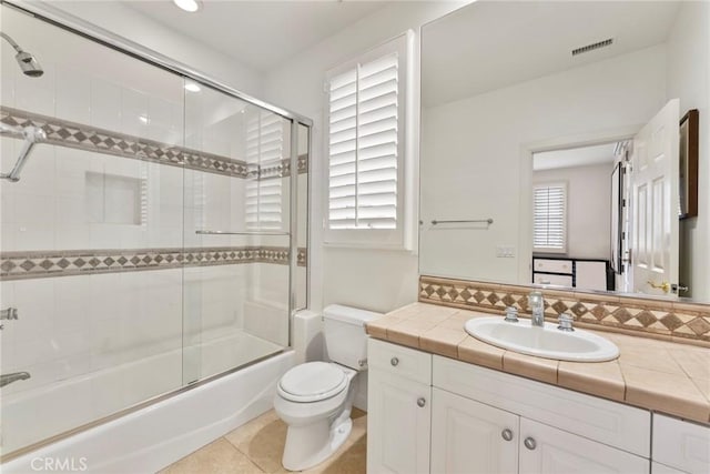12 Via Avoria, Newport Coast, CA 92657 - full bath with vanity, toilet, bath / shower combo with glass door, and tile patterned flooring