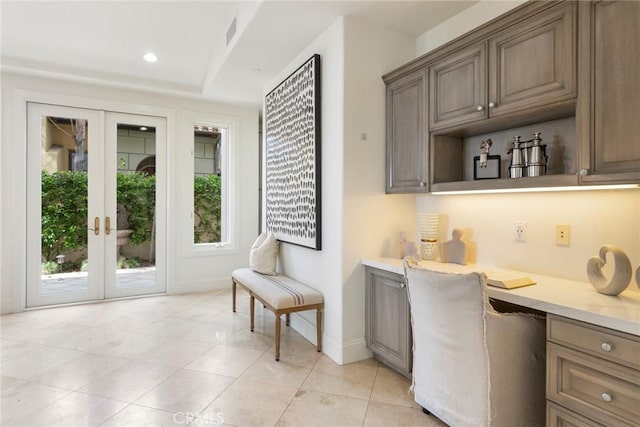 12 Via Avoria, Newport Coast, CA 92657 - bar featuring built in desk, baseboards, french doors, light tile patterned floors, and recessed lighting