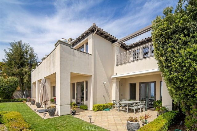12 Via Avoria, Newport Coast, CA 92657 - rear view of property with a balcony, a patio, stucco siding, and a lawn