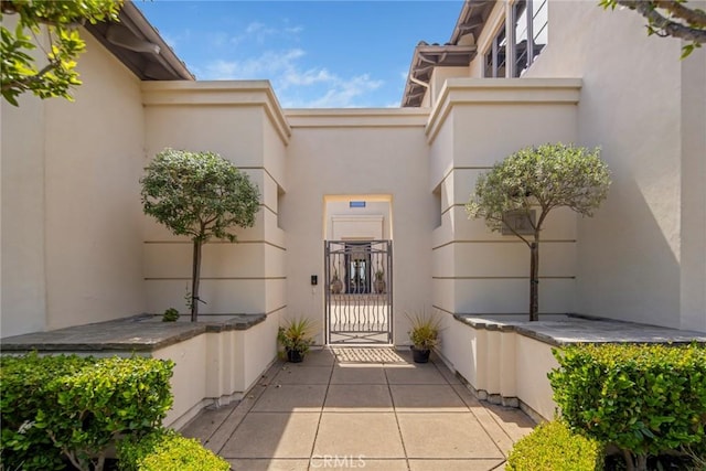 12 Via Avoria, Newport Coast, CA 92657 - doorway to property featuring stucco siding and a gate