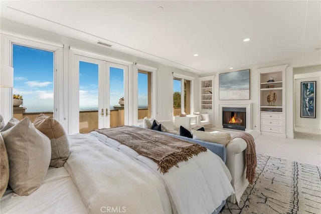 12 Via Avoria, Newport Coast, CA 92657 - bedroom featuring access to outside, a glass covered fireplace, french doors, and recessed lighting
