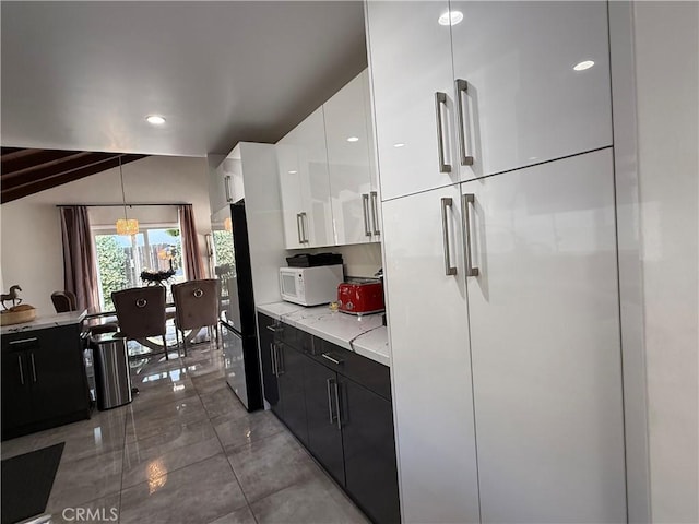 20630 Collegewood Dr, Walnut, CA 91789 - kitchen featuring white microwave, freestanding refrigerator, modern cabinets, dark cabinets, and white cabinets