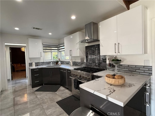 20630 Collegewood Dr, Walnut, CA 91789 - kitchen featuring wall chimney range hood, stainless steel stove, a sink, tasteful backsplash, and white cabinets
