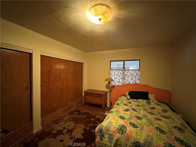 159 S Shasta St S, Willows, CA 95988 - bedroom featuring two closets and dark wood-style flooring