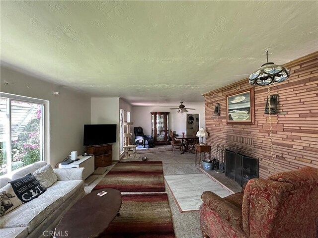 159 S Shasta St S, Willows, CA 95988 - carpeted living room featuring a textured ceiling, a brick fireplace, and a ceiling fan