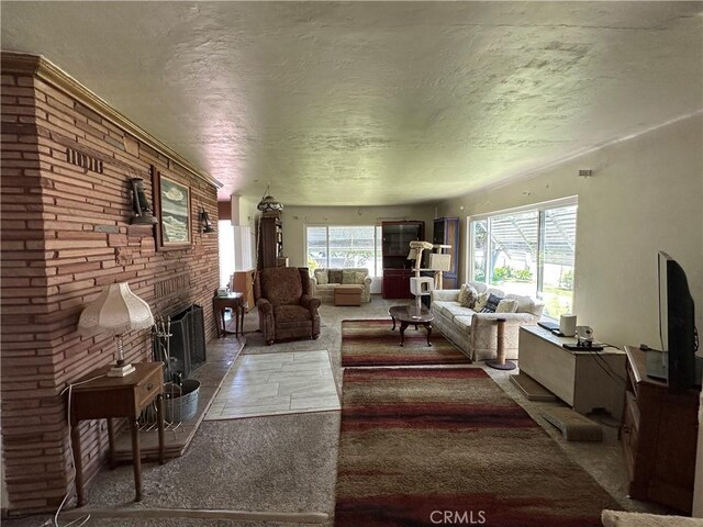 159 S Shasta St S, Willows, CA 95988 - living area featuring a fireplace with raised hearth, a textured ceiling, and stone finish flooring
