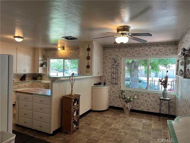 159 S Shasta St S, Willows, CA 95988 - kitchen featuring tile countertops, wallpapered walls, freestanding refrigerator, healthy amount of natural light, and ceiling fan